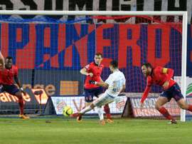 Marseilles midfielder Remy Cabella (C) shoots and scores a goal during a French L1 football match against Gazelec Ajaccio on March 9, 2016