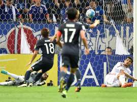 United Arab Emirates (UAE) goalkeeper goalkeeper Khalid Eisa (bottom left) blocking a shot. AFP