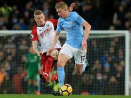 McClean pictured battling against Kevin de Bruyne. AFP