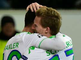 Wolfsburgs striker Andre Schuerrle (R) and Julian Draxler react after scoring during a UEFA Champions League match against Gent at the Volkswagen arena in Wolfsburg on March 8, 2016
