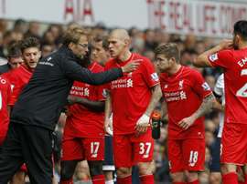Liverpool manager Jurgen Klopp talks to his players during a break in play during the Premier League match against Tottenham Hotspur at White Hart Lane on October 17, 2015