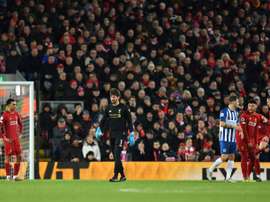 Van Dijk double keeps Liverpool at the top after nervy finish. AFP