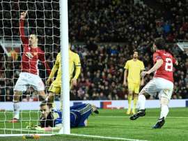 Manchester Uniteds midfielder Juan Mata (R) celebrates after scoring the opening goal