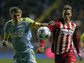 Astanas Kazakh defender Evgeni Postnikov (L) vies for the ball with Atletico Madrids forward Fernando Torres during the UEFA Champions League group C football match at the Astana Arena stadium in Astana on November 3, 2015
