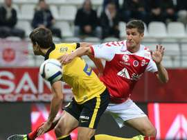 Reims French defender Anthony Weber (R) vies with Lilles Argentinian defender Renato Civelli during the French Ligue 1 football match on September 25, 2015 at the Auguste Delaune Stadium in Reims, northeastern France