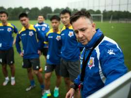 Gary White (R) has his eye on winning promotion to the Chinese Super League next season after saving Shanghai Shenxin from relegation