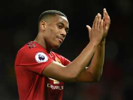 Martial says he is 'loving his time at the club' as he signs new deal. AFP
