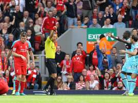 West Ham Uniteds Mark Noble (R) receives a red card from referee Kevin Friend (3rd R) for a challenge on Liverpools Danny Ings (Below L) during an English Premier League football match at Anfield in Liverpool on August 29, 2015