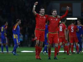 Waless midfielder Gareth Bale (L) and Waless midfielder Aaron Ramsey celebrate following Euro 2016 qualifying football match between Wales and Andorra at Cardiff City stadium in Cardiff, south Wales, on October 13, 2015