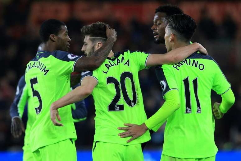 Liverpools English midfielder Adam Lallana (C) celebrates scoring his teams first goal with during the English Premier League football match between Middlesbrough and Liverpool at Riverside Stadium on December 14, 2016
