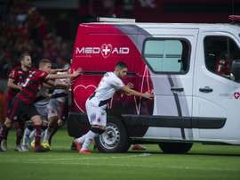 Players from both sides helped the vehicle off the pitch. AFP