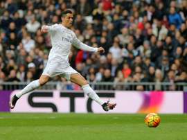 Real Madrids Portuguese forward Cristiano Ronaldo kicks the ball during the Spanish league football match Real Madrid CF vs Real Sociedad de Futbol at the Santiago Bernabeu stadium in Madrid on December 30, 2015