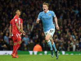 Manchester Citys midfielder Kevin De Bruyne (R) celebrates after scoring during a UEFA Champions league Group D football match against Sevilla in Manchester on October 21, 2015