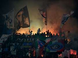 Inter Milan supporters light fireworks during the Italian Serie A football match Inter Milan vs AC Milan at the San Siro Stadium in Milan on April 19, 2015