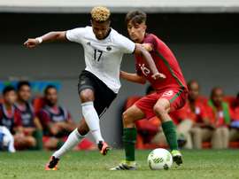 Serge Gnabry (left) fends off Portugals Fernando in Brasilia on August 13, 2016