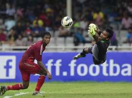 Bangladesh goalkeeper Rasel Mahmud (R) jumps to save the ball as teammate Mohammed Yasin Khan looks on during the Asia Group B FIFA World Cup 2018 qualifying match against Tajikistan at the Bangabandhu National Stadium in Dhaka on June 16, 2015