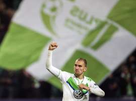 Wolfsburgs forward Bas Dost celebrates at the final whistle of the Group B, first-leg UEFA Champions League football match against Eindhoven on October 21, 2015