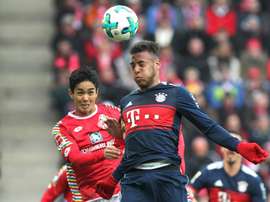 Muto battles Corentin Tolisso. AFP