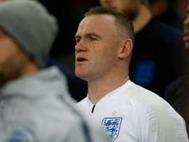 Rooney prepares to come on. AFP