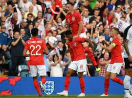 Phil Jones celebrates with England teammates. AFP