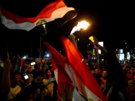 Les Egyptiens dans les rues du Caire après leur victoire face au Zimbabwe. AFP