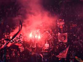 PSG supporters set off flairs during their side's clash with Real. AFP