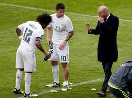 Marcelo and James talking to Zidane. AFP