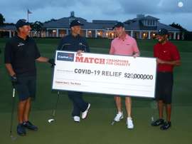 A handout photo made available by Getty Images for the Match shows United States golfer Tiger Woods (R) and former National Football League (NFL) player Peyton Manning (2-R) celebrating defeating golfer Phil Mickelson of the US (L) and NFL player Tom Brady of the Tampa Bay Buccaneers (2-L) on the 18th green during The Match: Champions for Charity at Medalist Golf Club in Hobe Sound, Florida, USA, 24 May 2020. EFE/MIKE EHRMANN