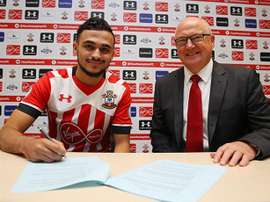 Boufal is pictured signing his Southampton contract. SainstFC