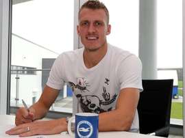 Dan Burn signs his Brighton contract. Twitter/OfficialBHAFC