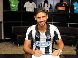Lazaar signs his contract with Newcastle. NUFC