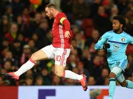 Wayne Rooney kicking the ball during an Europa League match. Goal