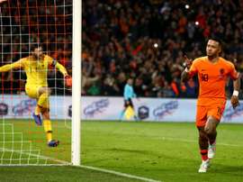 Memphis Depay celebrates scoring against Lloris. GOAL