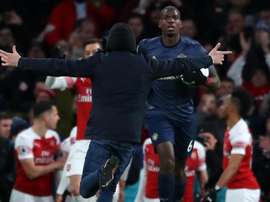 Paul Pogba was confronted by a pitch invader at the Emirates. GOAL