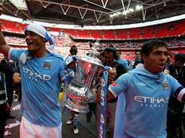 Vincent Kompany holds the FA Cup with Carlos Tevez. GOAL