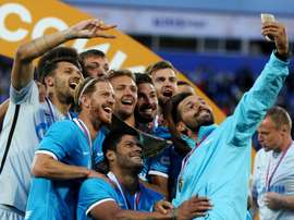 Zenit St. Petersburg players pose for a selfie with the trophy after winning their Russian Super Cup match against Lokomotiv Moscow at the Petrovsky stadium in St. Petersburg on July 12, 2015