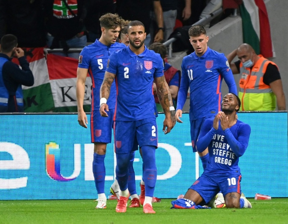 Englands forward Raheem Sterling celebrates his opening goal, with a cup thrown by Hungary fans. AFP