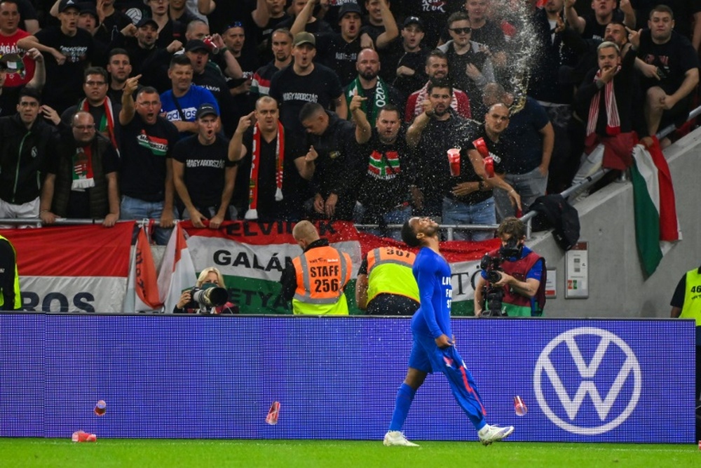 Hungary fans react throwing cups of beer at England forward Raheem Sterling. AFP