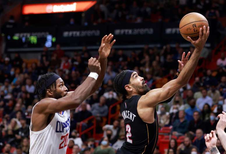 Gabe Vincent (d) de Miami Heat lanza alrededor de Justise Winslow (i) de Los Angeles Clippers, durante el partido de baloncesto de la NBA, hoy, en el FTX Arena de Miami, Florida (EE.UU.). EFE/Rhona Wise
